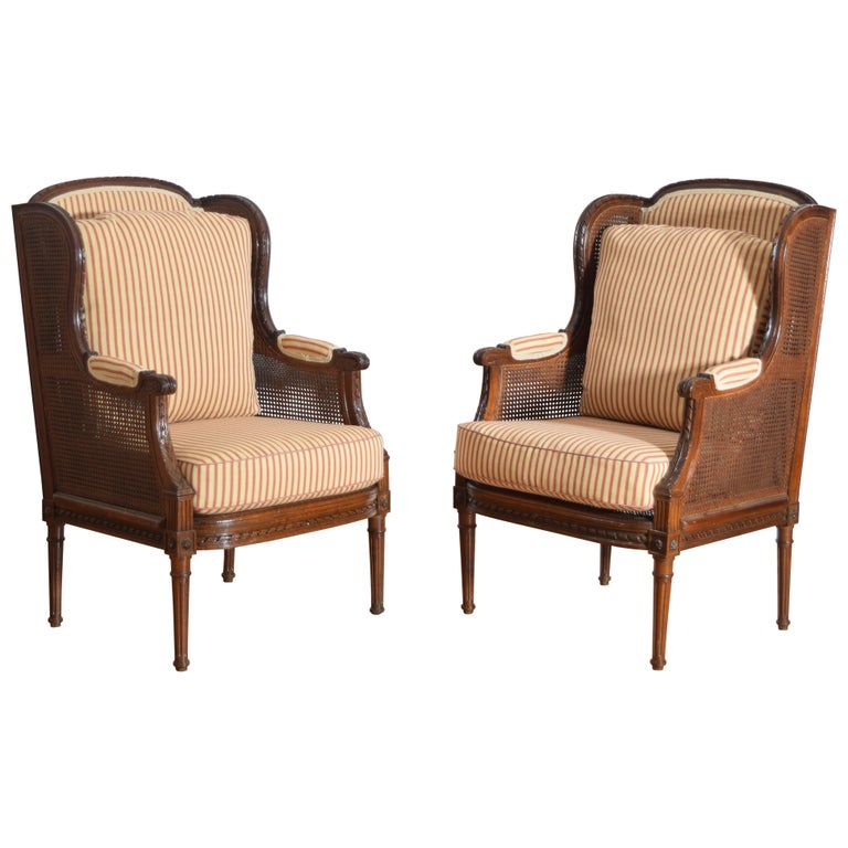 Pair of Carved Walnut and Caned Bergeres
