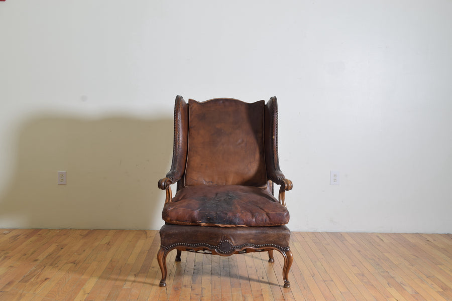 Carved Walnut and Leather Upholstered Wing Chair