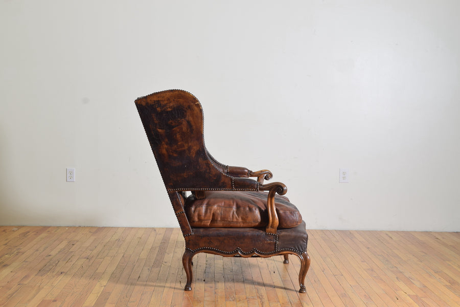 Carved Walnut and Leather Upholstered Wing Chair