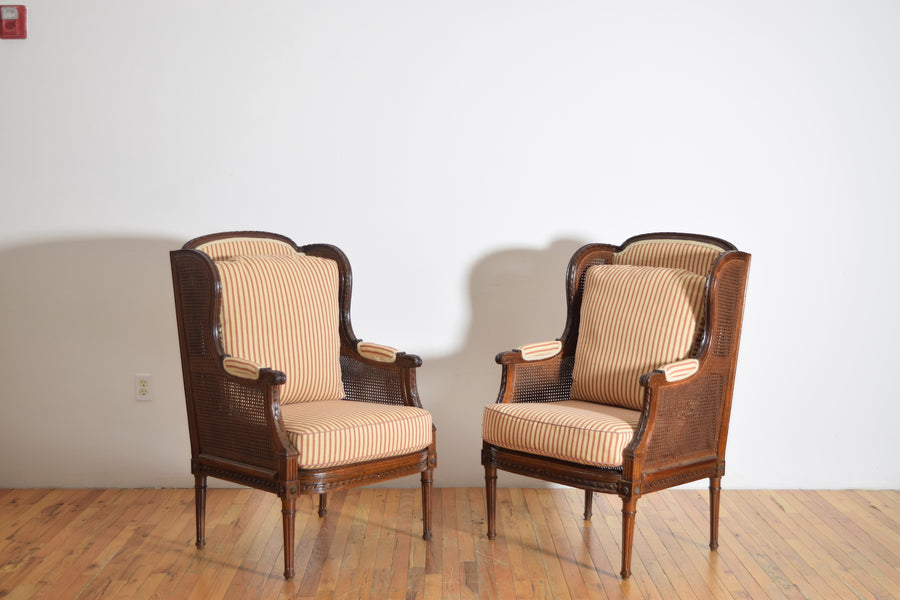 Pair of Carved Walnut and Caned Bergeres
