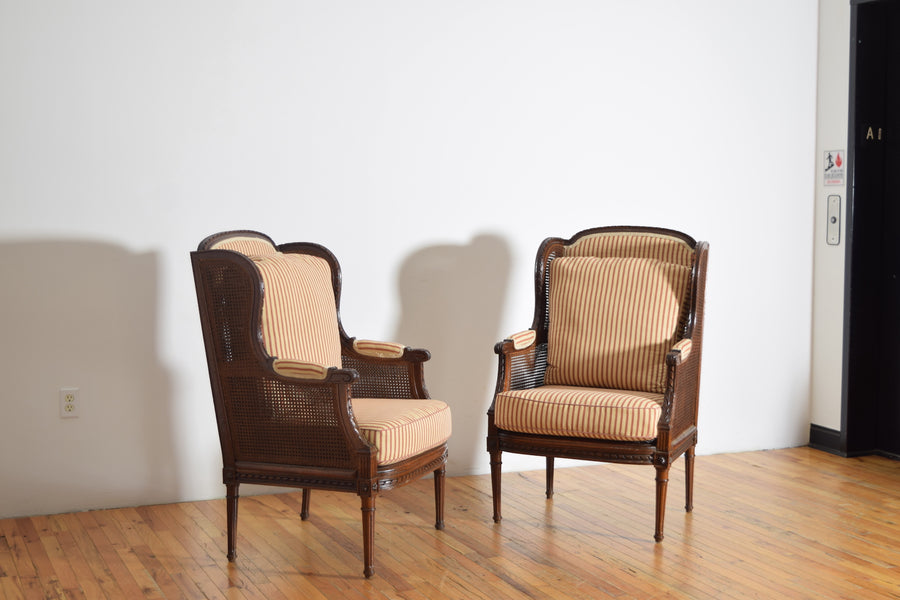 Pair of Carved Walnut and Caned Bergeres