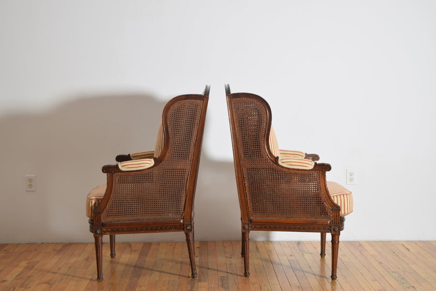 Pair of Carved Walnut and Caned Bergeres