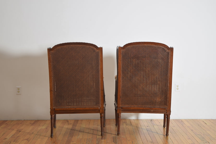 Pair of Carved Walnut and Caned Bergeres