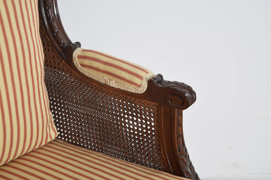 Pair of Carved Walnut and Caned Bergeres