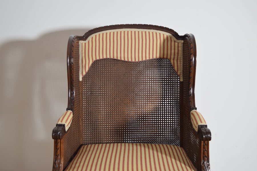 Pair of Carved Walnut and Caned Bergeres